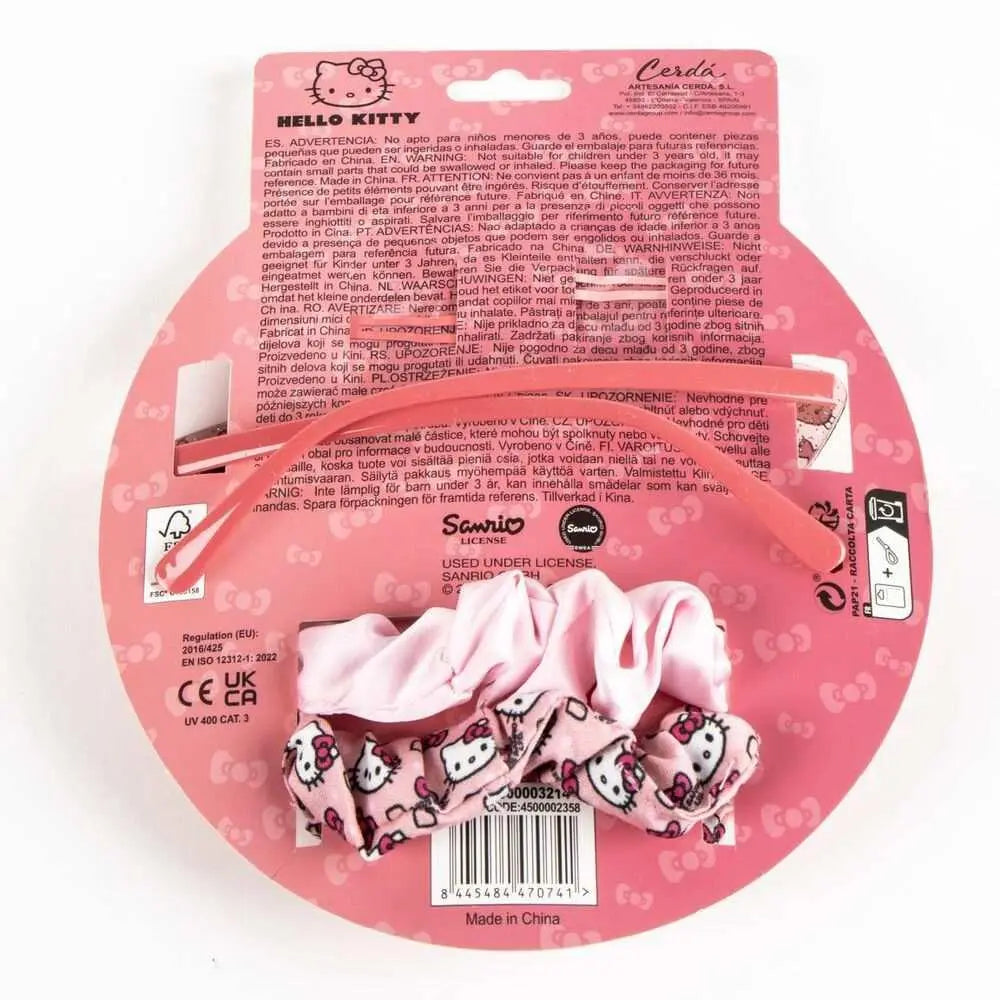 Set accessori capelli Hello Kitty rosa su confezione con logo Sanrio e sfondo rosa, Nerdscape.