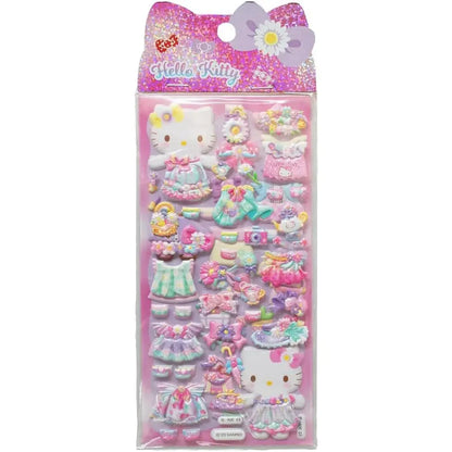 Adesivi 3D Hello Kitty colorati, vestiti e accessori kawaii, confezione su sfondo rosa Nerdscape